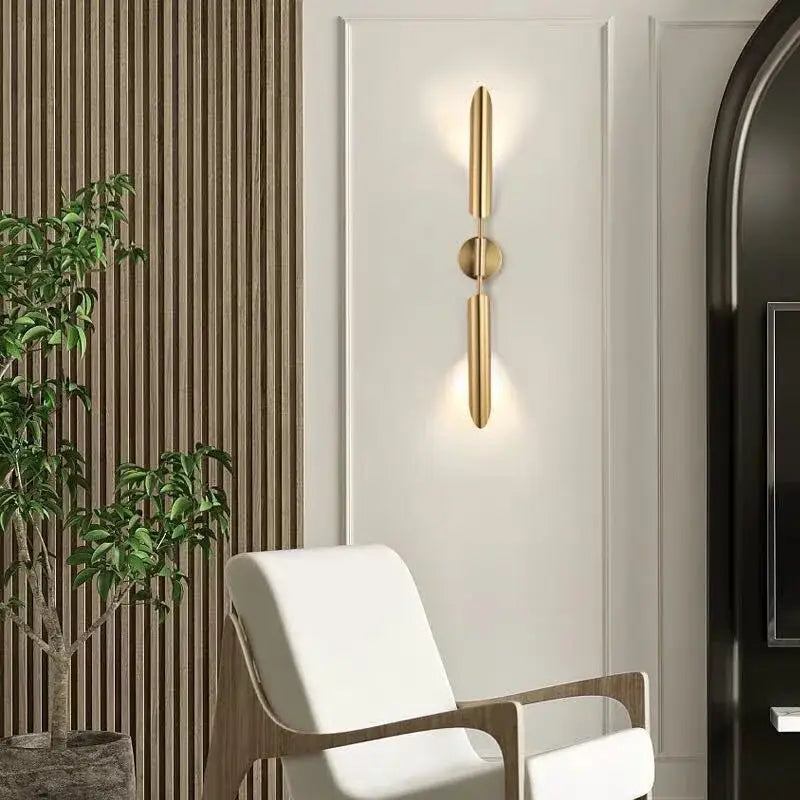 Modern golden inclined tube wall light featuring gold-toned minimalist vertical bars and a central circular accent for decorbites wall light