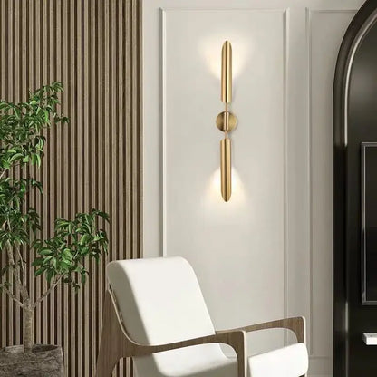 Modern golden inclined tube wall light featuring gold-toned minimalist vertical bars and a central circular accent for decorbites wall light