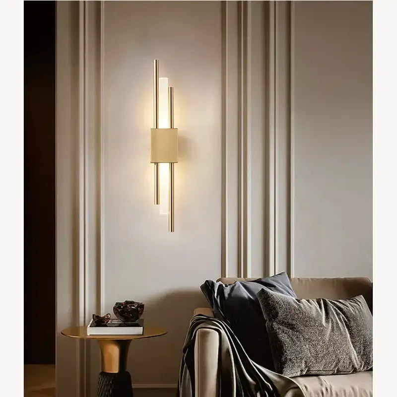 Modern golden led wall lamp featuring gold-toned vertical rods and a frosted glass diffuser for ambient bedroom lighting decorbites golden led