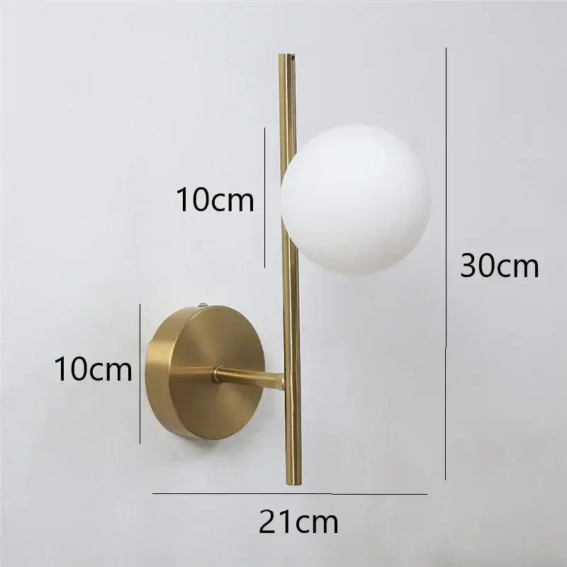 Modern golden led wall light with a gold-toned vertical rod and frosted white milky glass sphere for bedroom decorbites golden led
