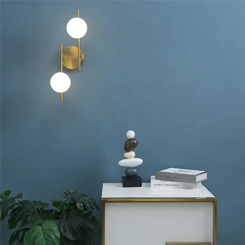 Modern golden led wall lights with two spherical milky glass shades from decorbites golden led bedroom sconce