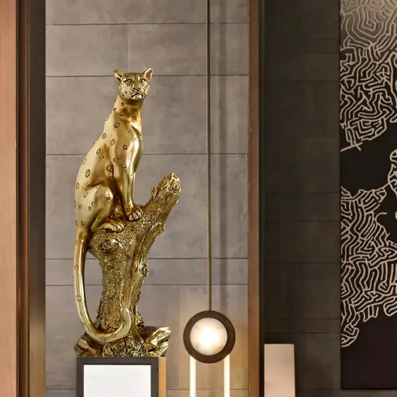 Modern decorbites golden leopard resin sculpture with detailed spotted pattern seated on textured tree stump base