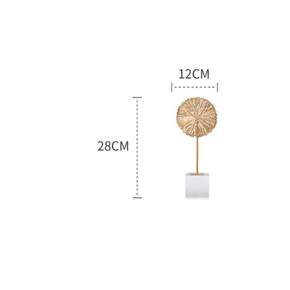 Gold-toned lotus sculpture with intricate texture on slender stem and clear acrylic base for modern living room decor