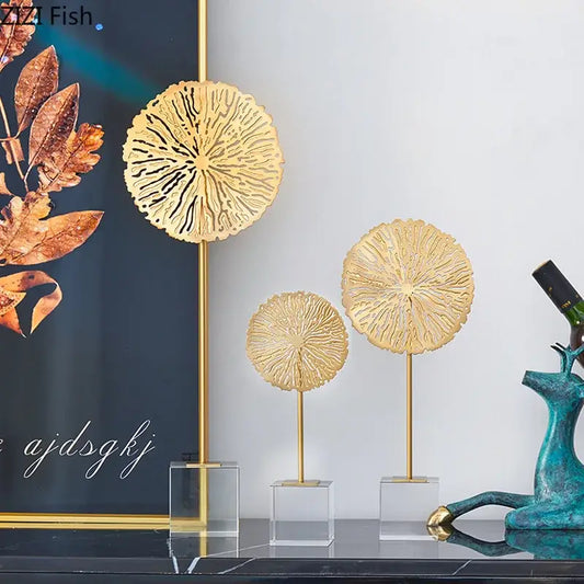 Modern golden lotus sculpture featuring intricately detailed lotus leaves on slender metal stands for living room decor