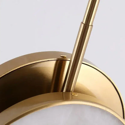 Modern golden marble led pendant light with gold-toned metal cylindrical stem and circular base for bedroom decorbites golden marble