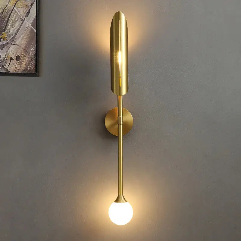 Golden metal glass wall lamp featuring a modern golden metal decorbites sconce with a spherical bulb spotlight