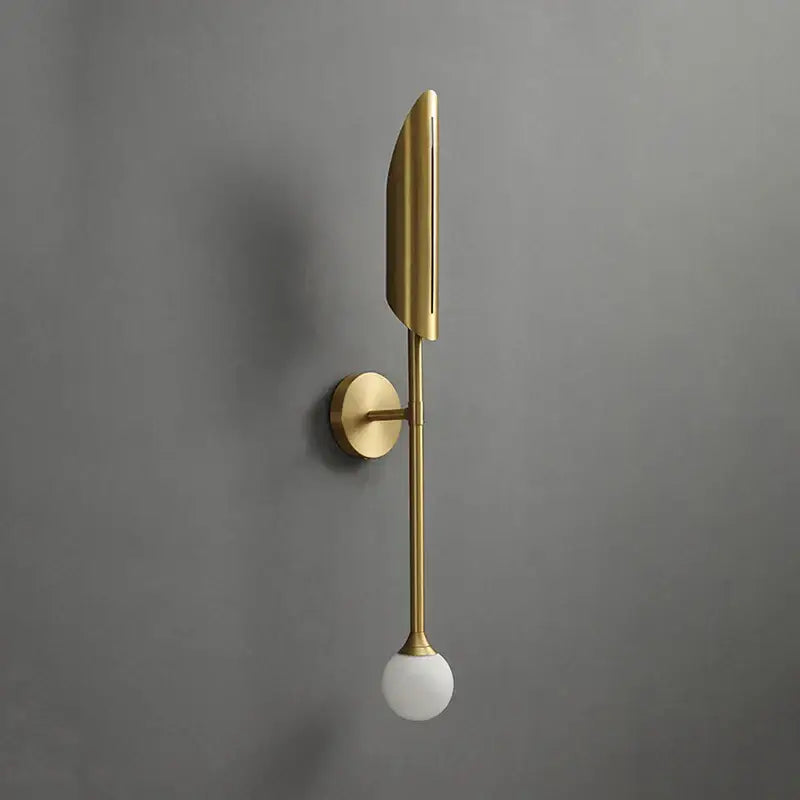 Modern golden metal glass wall lamp with gold-toned elongated blade shade and frosted globe for bedroom sconce decorbites golden metal
