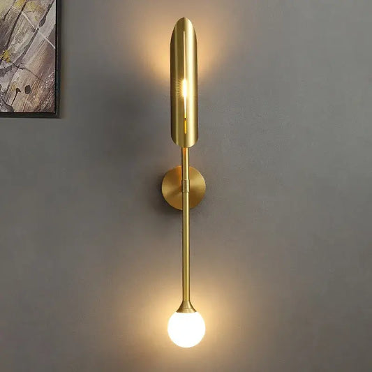 Modern golden metal led wall lamps with sleek elongated design and spherical bulb for bedroom and living room decorbites decor