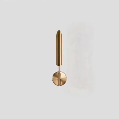 A modern golden metal led wall lamp with polished brass finish and slender vertical rod design for bedroom decorbites decor