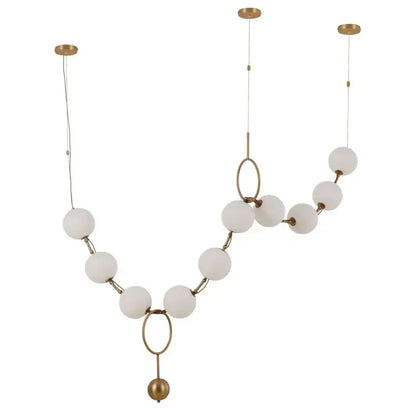 A modern golden necklace chandelier with frosted white glass bulbs and metal rings for dining room luxury lighting