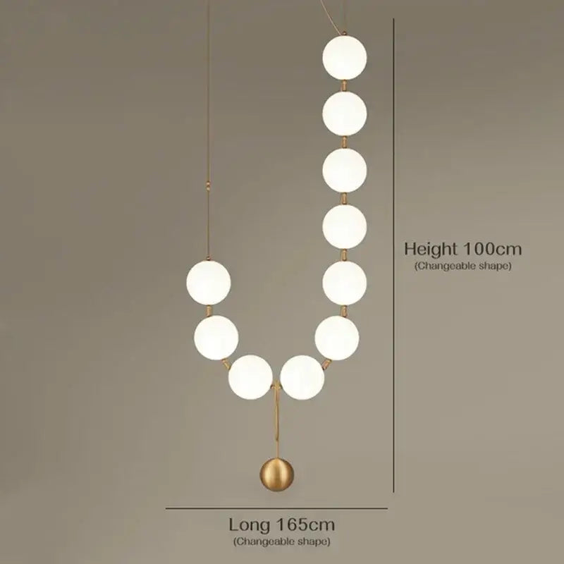 Modern golden necklace chandelier featuring frosted white spherical bulbs and slender gold-toned rods for dining room luxury lighting