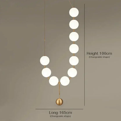 Modern golden necklace chandelier featuring frosted white spherical bulbs and slender gold-toned rods for dining room luxury lighting