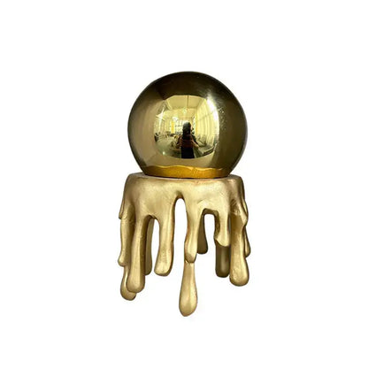 Golden octopus spherical ornament featuring a glossy crystal ball with a dripping gold base for living room decor