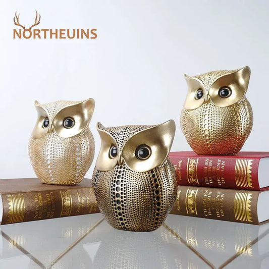 Three golden perforated owl figurines with black eyes metallic finish modern decorbites animal statues for living room