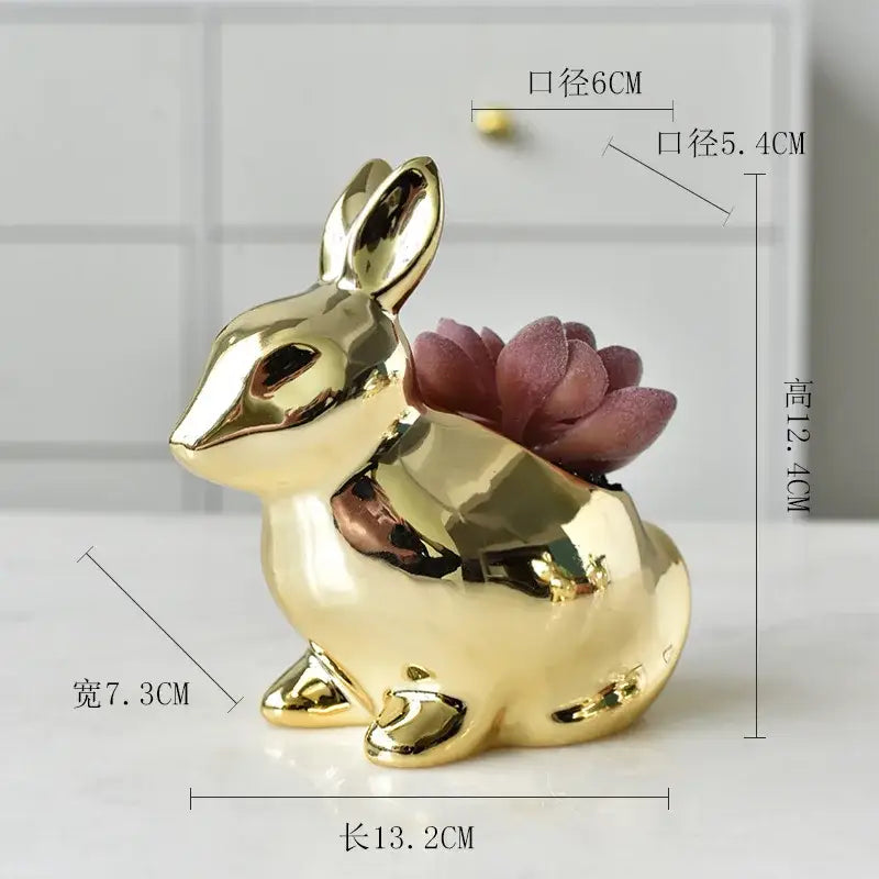 Modern golden rabbit ceramic flower pot with glossy finish holding a small purple succulent for living room decor