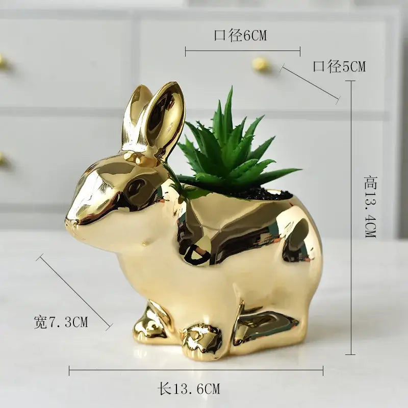 Modern golden ceramic flower pot shaped like a rabbit with a glossy finish and a green succulent inside for living room decor