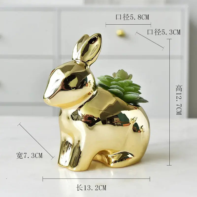 Shiny gold ceramic flower pot shaped like a rabbit with a small green succulent for modern living room decor