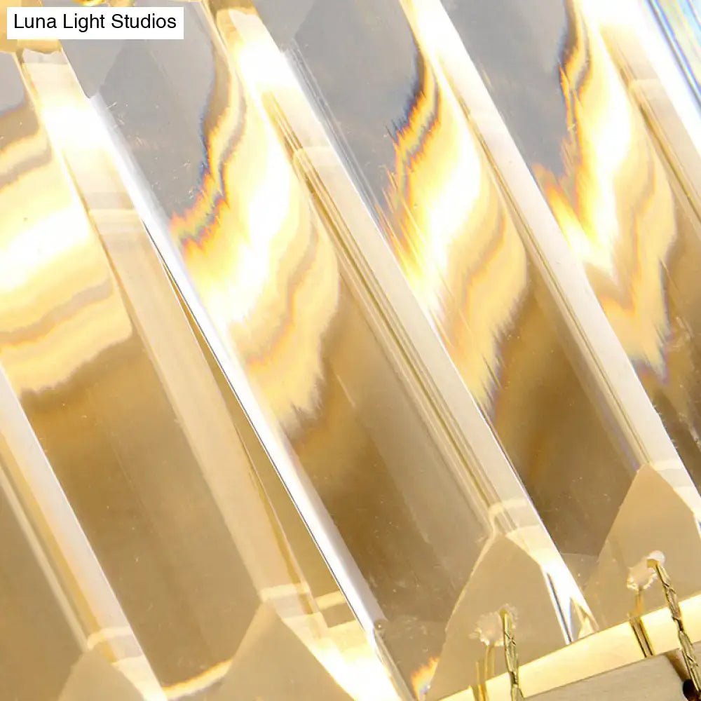 Modern golden rectangle led wall sconce featuring clear faceted crystal arms with warm golden light reflections