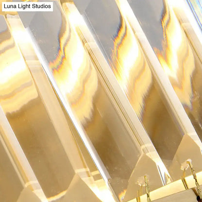 Modern golden rectangle led wall sconce featuring clear faceted crystal arms with warm golden light reflections