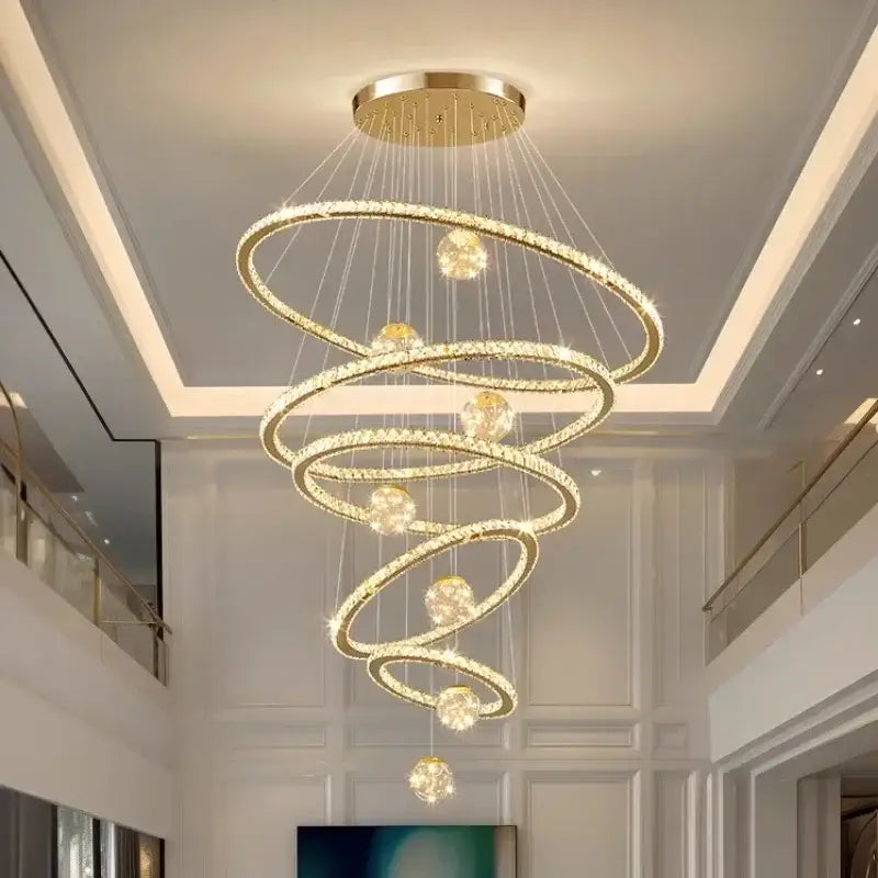 A modern golden spiral decorbites crystal led chandelier with clear crystal-encrusted rings and spherical lights for living rooms