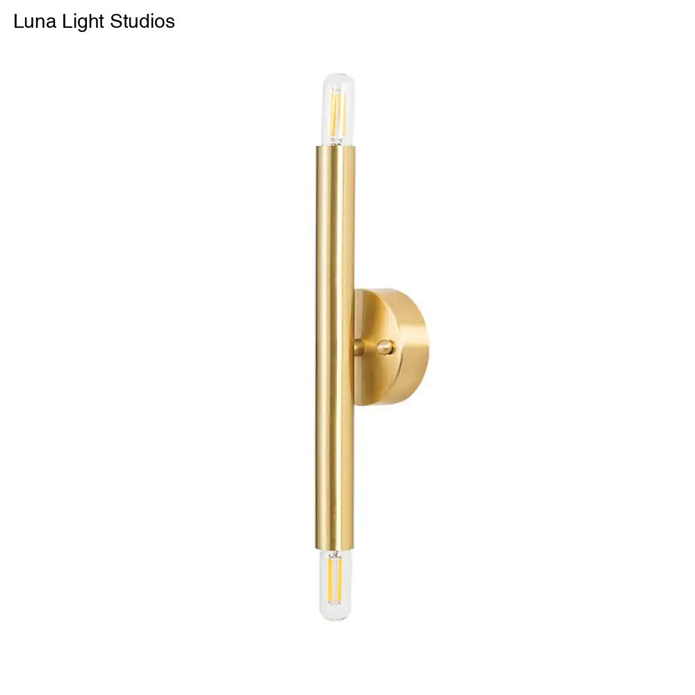 Modern golden tubular wall lamp with brass finish and two clear glass led bulbs for bedroom lighting