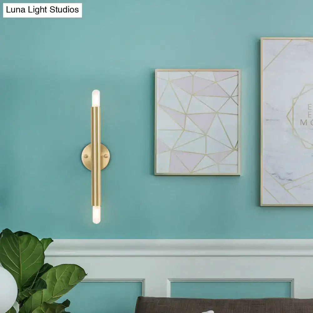 Modern golden tubular wall lamp featuring gold-toned cylindrical design with frosted glass accents for bedroom use