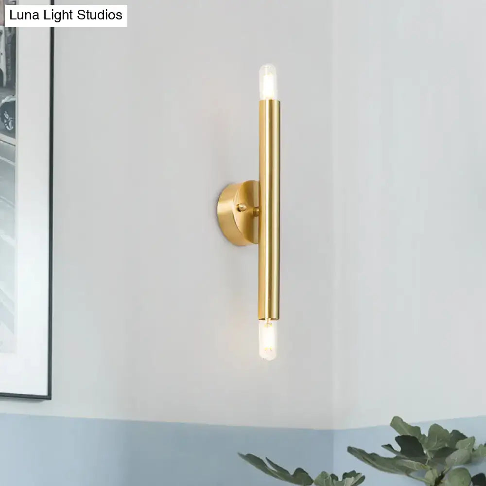 Modern golden tubular wall lamp with gold-toned cylindrical body and frosted glass accents for bedroom lighting
