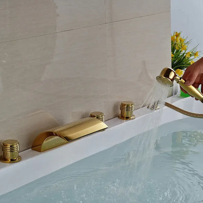 Modern golden widespread brass bathtub faucet with handheld shower featuring three cylindrical handles in sleek design
