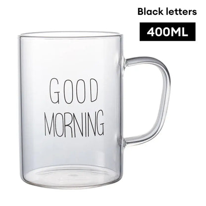 Modern good morning glass mug with clear glass and sleek curved handle featuring decorbites good morning print