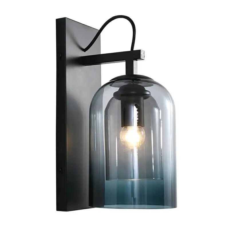 Black metal wall-mounted lamp with modern gradient glass dome in blue tint housing an exposed bulb for bedroom use