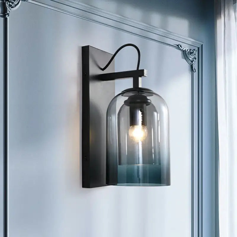 Black metal wall-mounted lamp with modern gradient glass blue-tinted dome and exposed bulb for bedroom lighting fixture