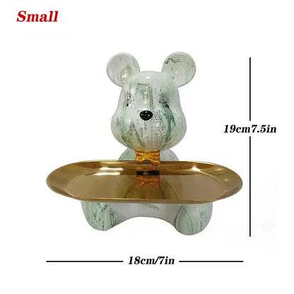 A small translucent green and white marbled bear figurine with gold tray for decorbites graffiti bear key storage