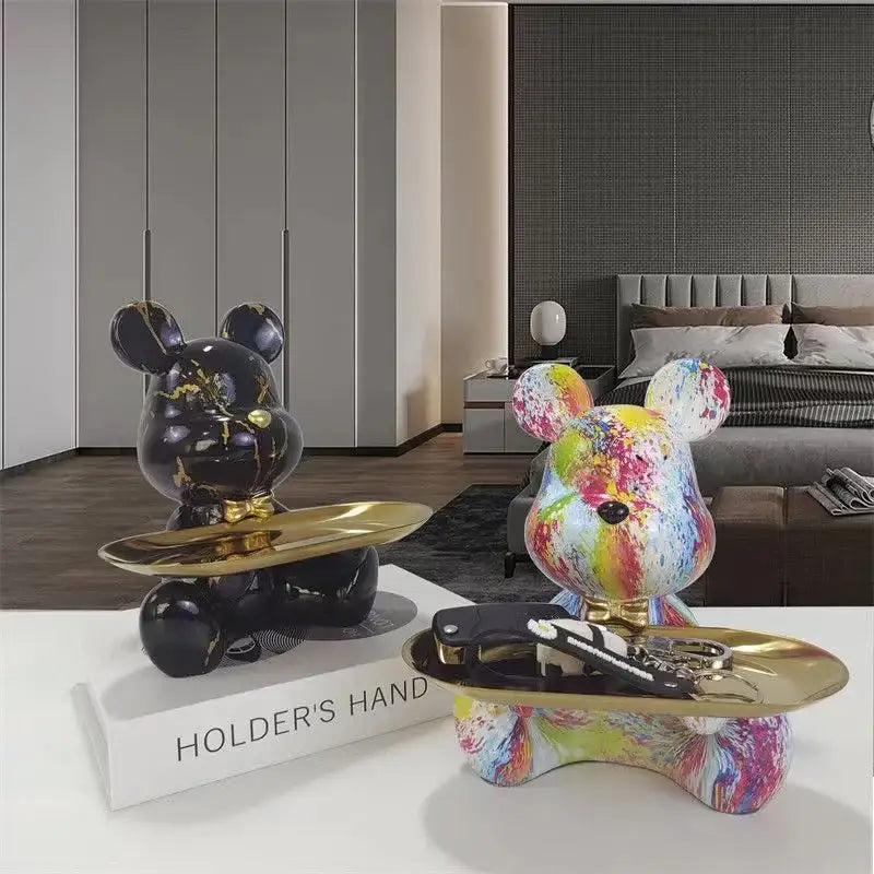 Two bear figurines with glossy black gold marble and multicolored splatter paint finishes on golden trays for decorbites graffiti bear shelf