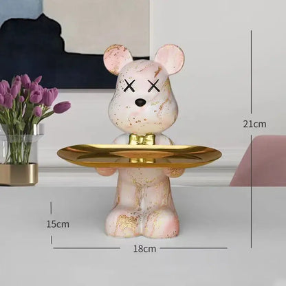Pink marble-effect bear figurine with gold leaf accents and bow tie on a golden tray decorbites graffiti bear decor