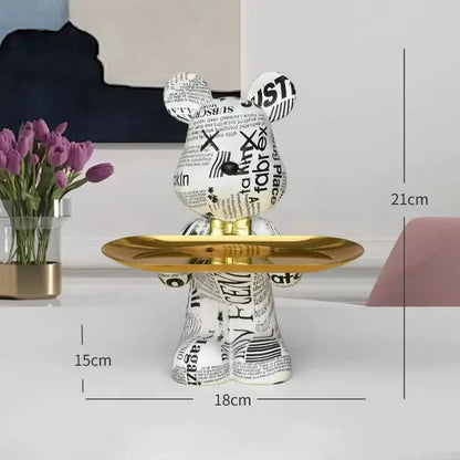 Modern graffiti bear figurine in white and black newspaper print with a gold tray for living room decor storage