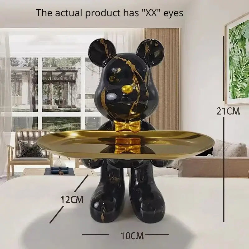 Black bear statue ornament with gold marble streaks and shiny bow tie holding reflective brass tray for home decor