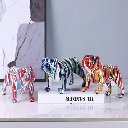 Three vibrant decorbites bulldog figurines with glossy ceramic finish and bold red blue green gold and black stripes