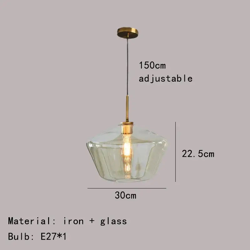 Modern pendant lamp with a clear gray amber glass shade and brass-toned iron hardware for dining room lighting decorbites gray amber