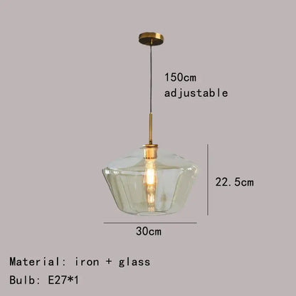 Modern pendant lamp with a clear gray amber glass shade and brass-toned iron hardware for dining room lighting decorbites gray amber