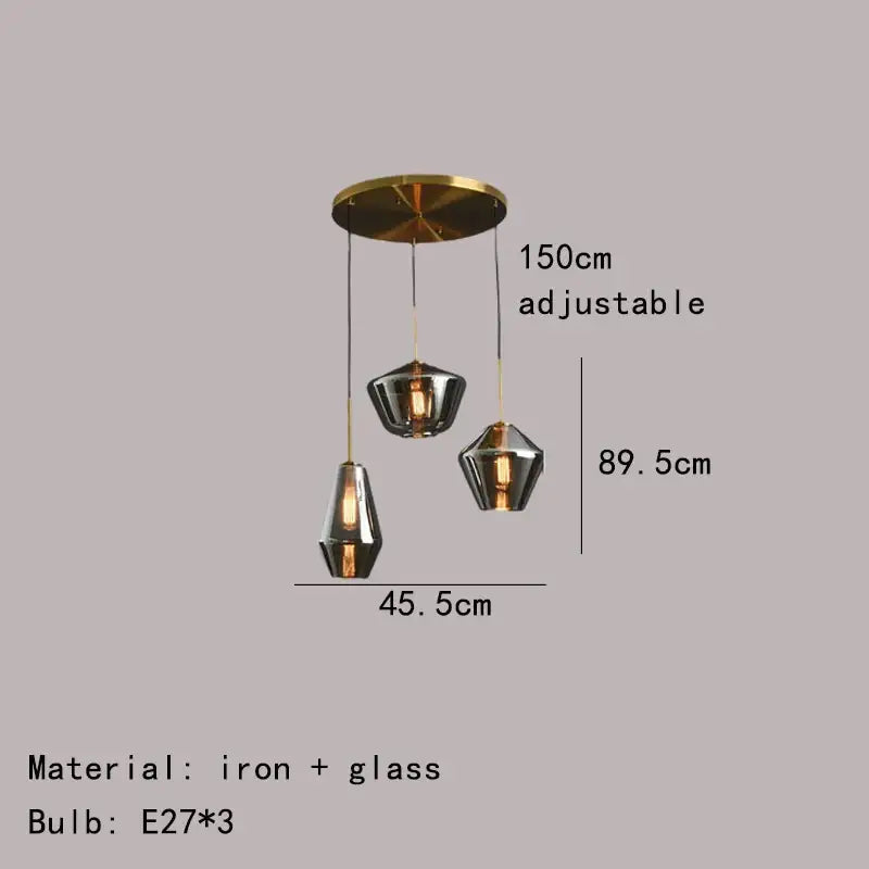 Modern pendant lamp with brass-finished iron mount and gray amber glass shades for dining room decorbites gray amber lighting