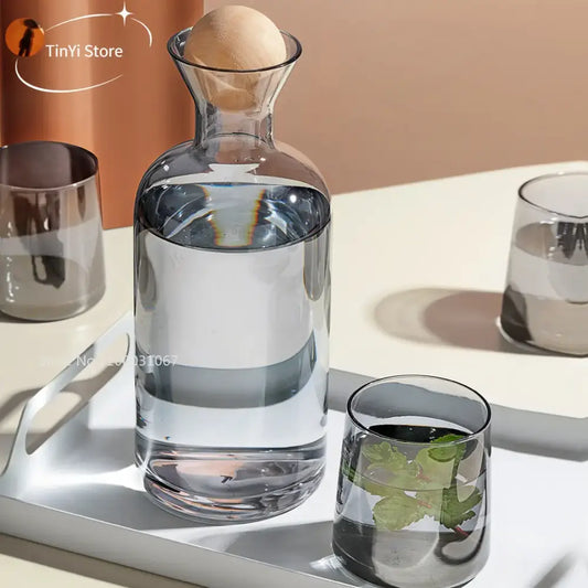 Modern gray amber glass water pitcher with rounded body narrow neck and wooden stopper for kitchen use