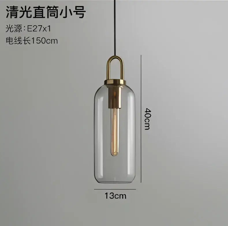 Modern gray and brass glass pendant light fixture with clear glass and exposed Edison bulb for kitchen lighting
