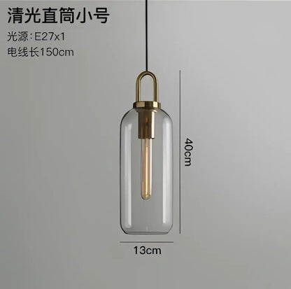 Modern gray and brass glass pendant light fixture with clear glass and exposed Edison bulb for kitchen lighting