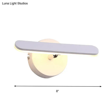 Modern gray and white linear vanity lighting wall sconce with a sleek matte gray rectangular light bar on white wall