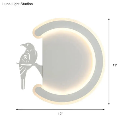 Modern gray metal wall lamp with bird silhouette featuring warm white light crescent sconce for bedroom use