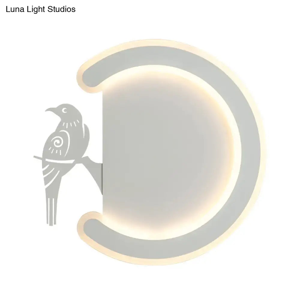 Modern gray wall lamp with crescent shape and bird silhouette providing warm white light for bedroom ambiance