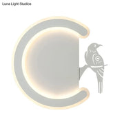 Modern gray wall lamp with a sleek curved frame and warm white light featuring a stylized bird silhouette