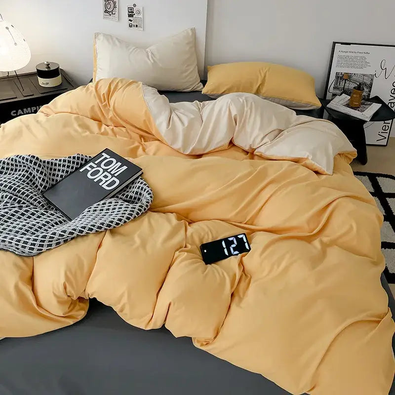 A cozy two-toned comforter cover set in soft mustard yellow and creamy white satin for modern bedroom bedding