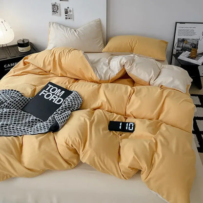 Warm yellow and cream two-tone quilted duvet in a modern gray comforter cover set with geometric throw cover set