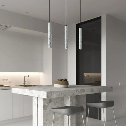 Modern gray concrete tube pendant light dining room triple chandelier with speckled finish hanging above kitchen island